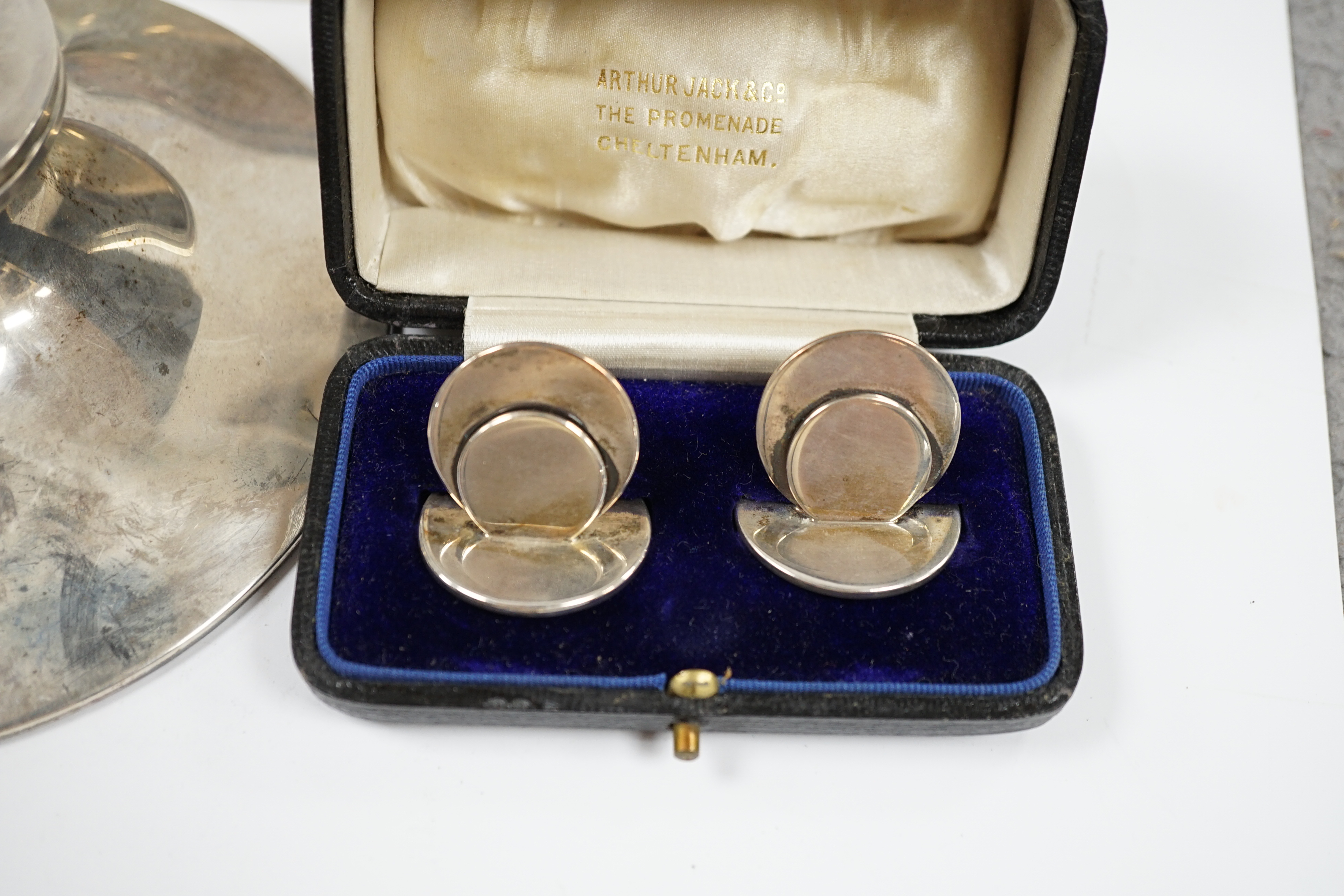 A silver mounted capstan inkwell, Birmingham, 1914, a silver mounted cigarette box and a cased pair of silver menu holders. Condition - poor to fair